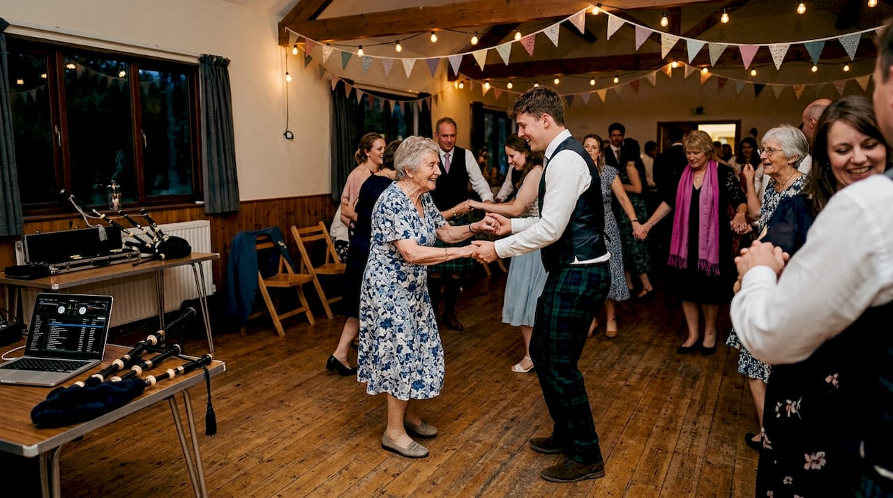 Guests dancing ceilidh at Scottish wedding