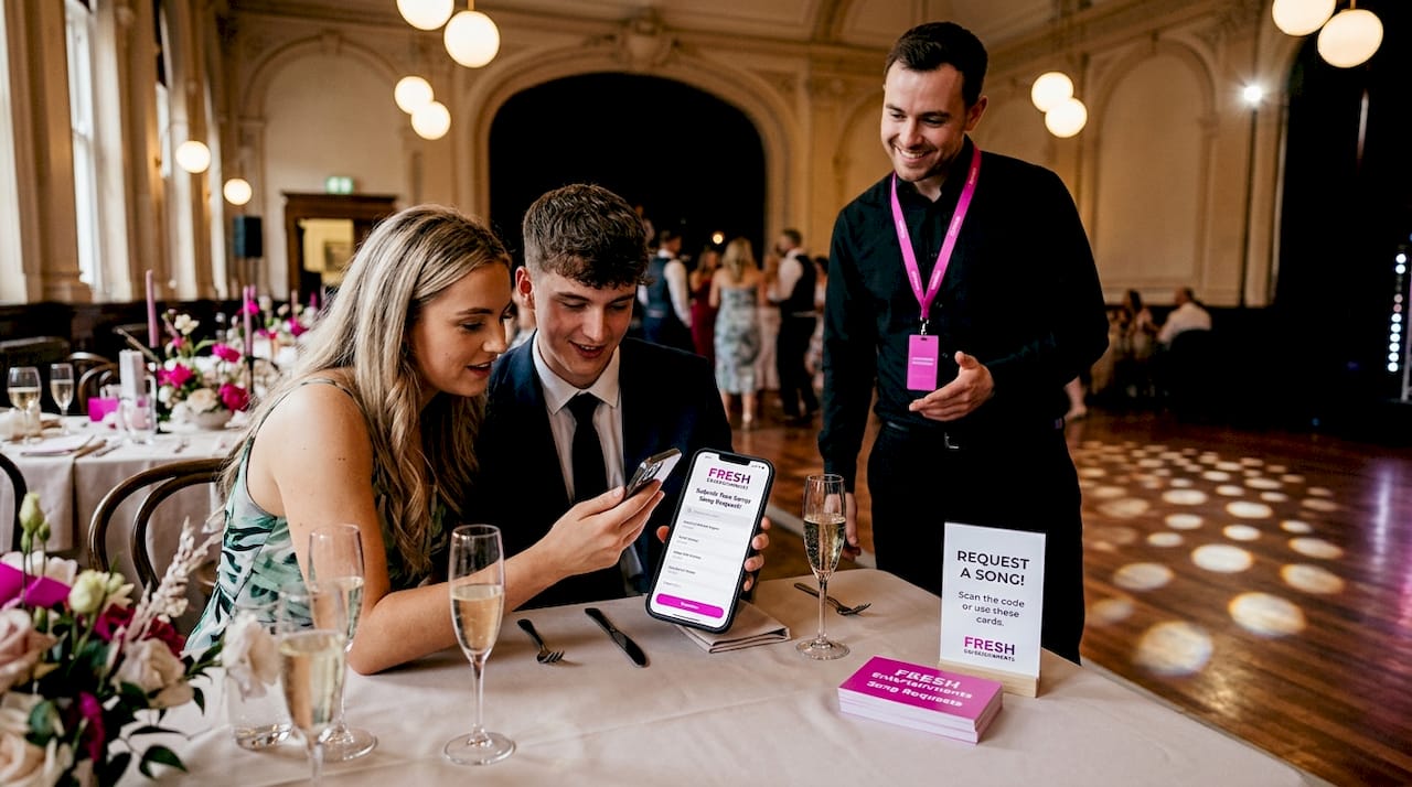 Guests submitting song requests at wedding table