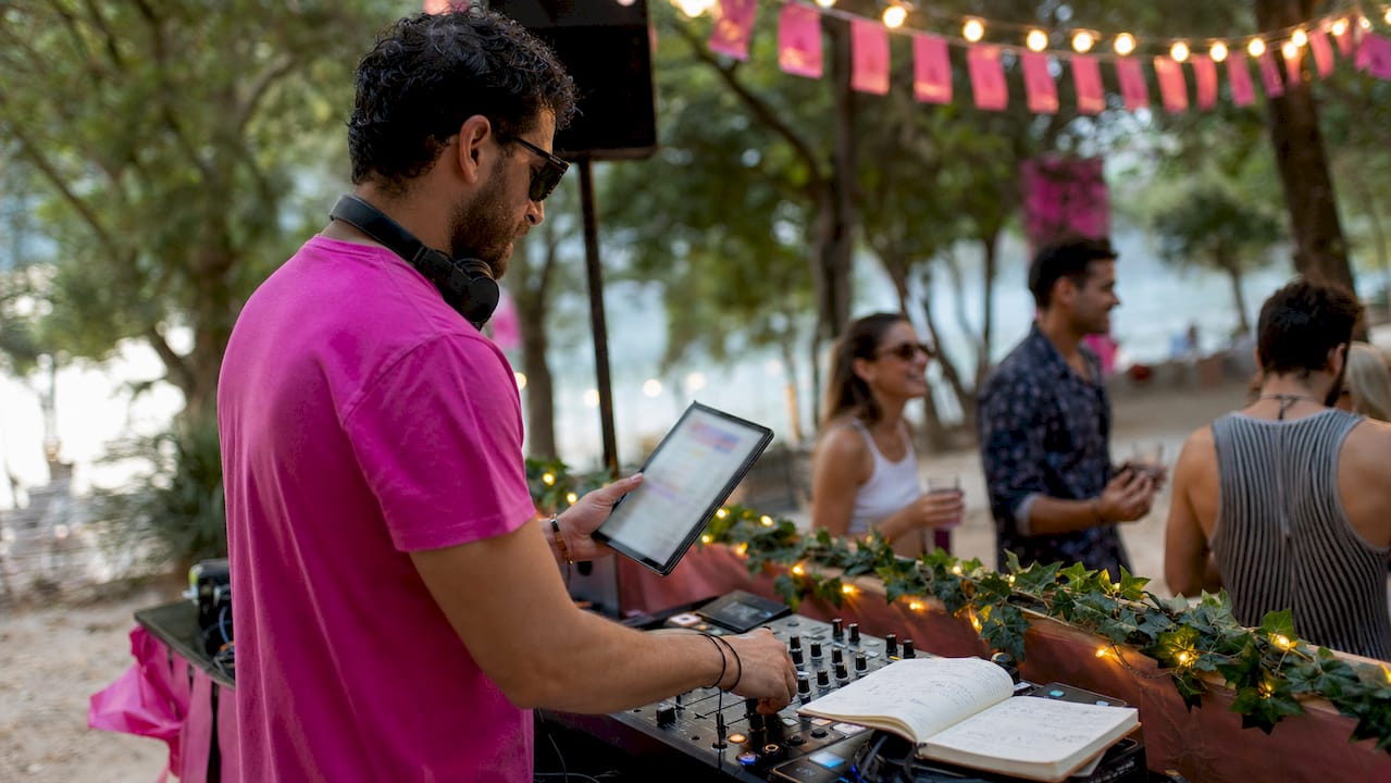 DJ managing digital song requests on tablet