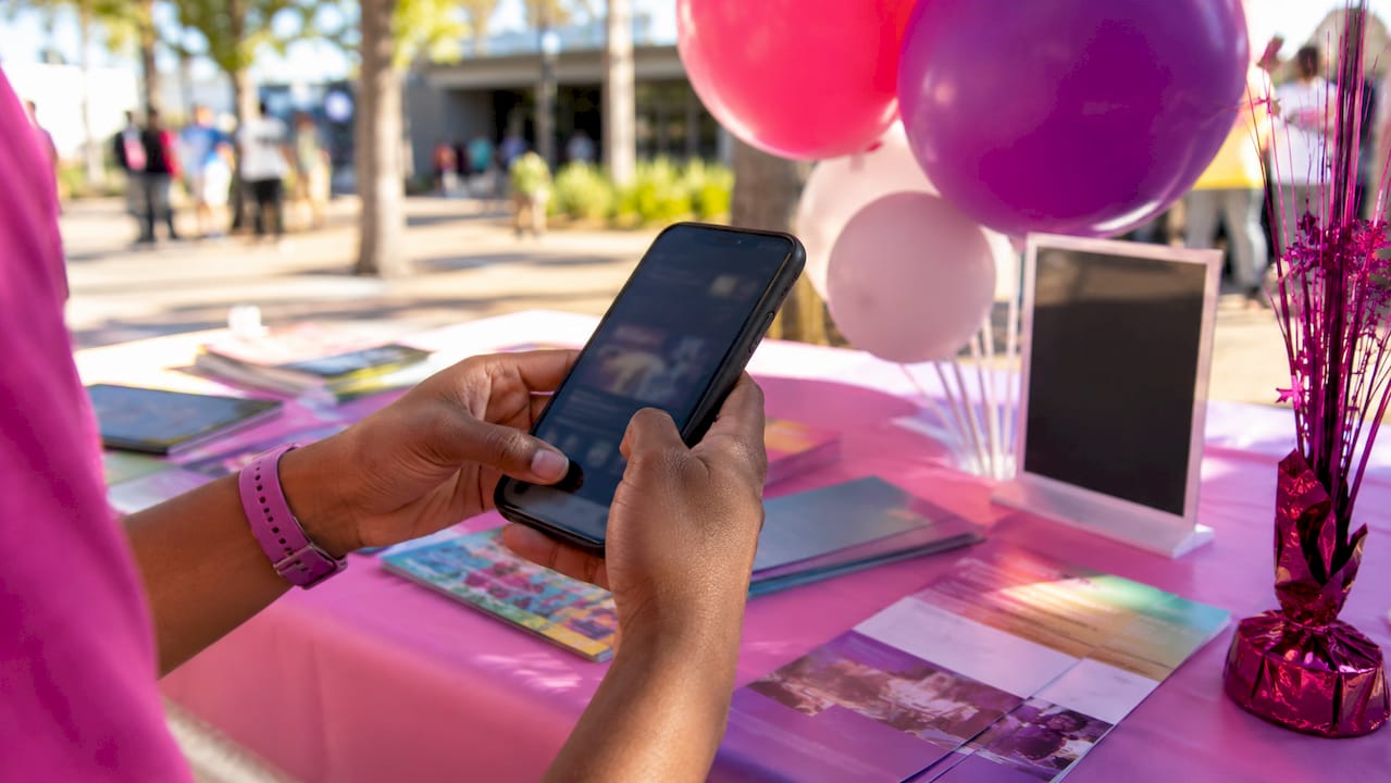 Hands using event app on smartphone for engagement