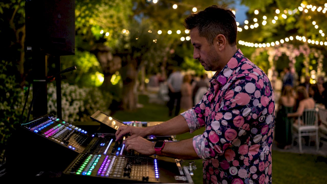 Hands adjusting wedding lighting console