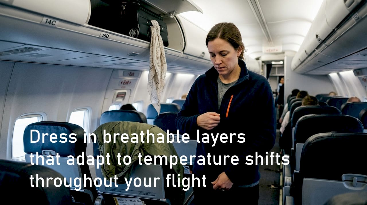 Traveler dressing in layers in airplane aisle