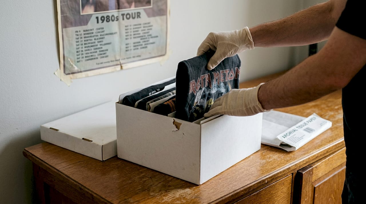 Folding vintage shirts into upright archival storage