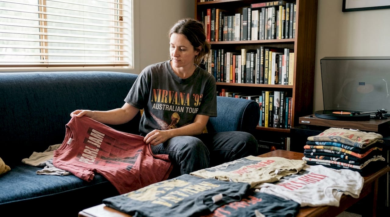 Collector examining vintage metal tour shirts