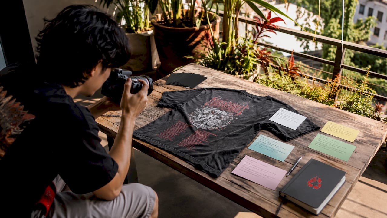 Hands photographing vintage metal shirt details
