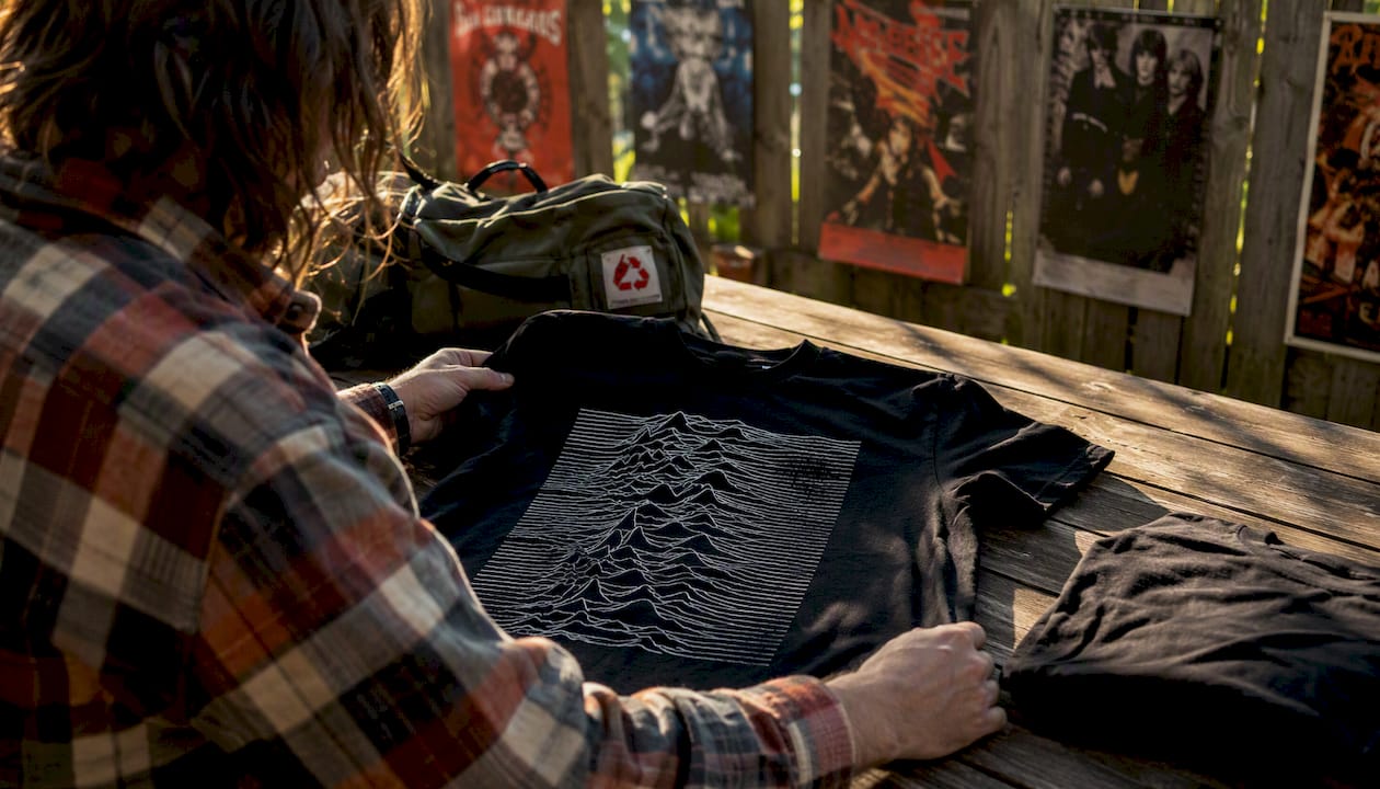 Hands holding Joy Division Unknown Pleasures t-shirt flat