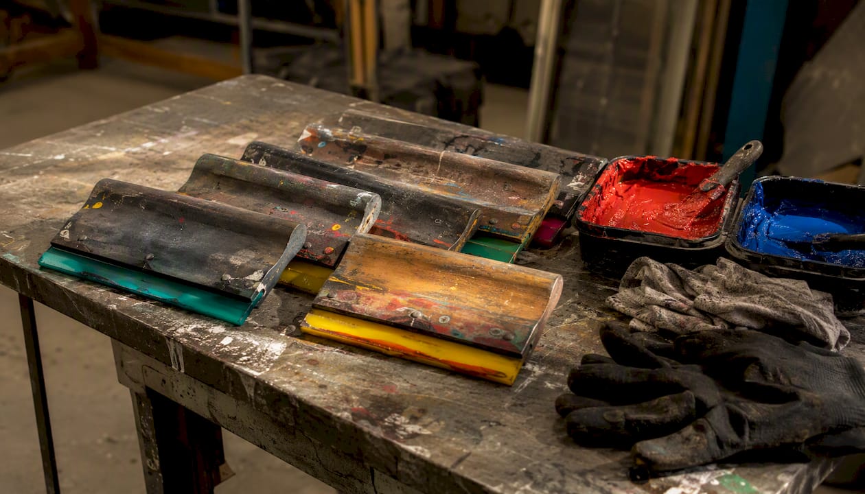 Various squeegees on a workshop table