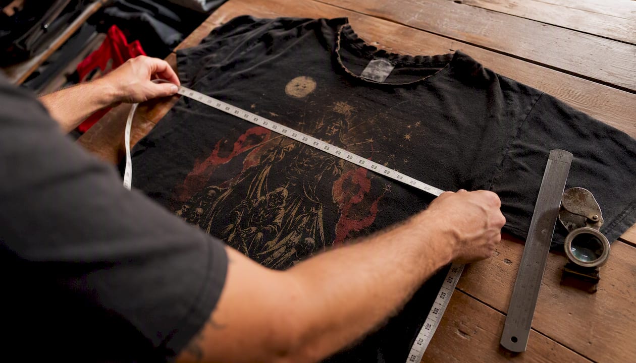 Measuring vintage band shirt with tape measure