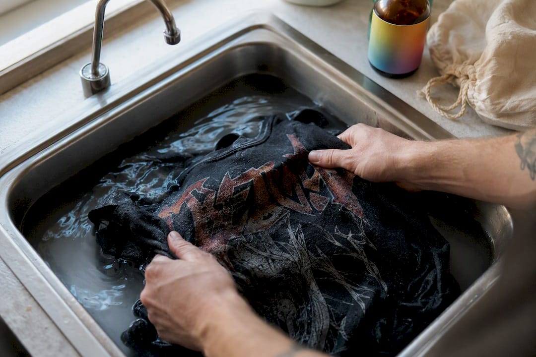 Hands hand washing vintage band shirt