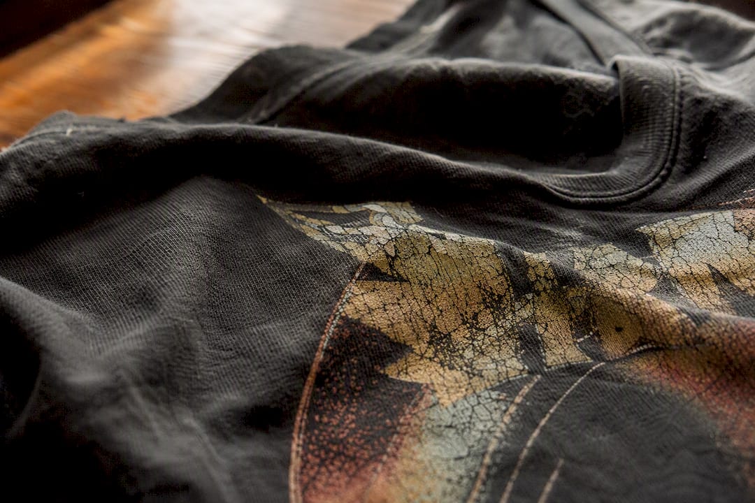 Close-up of worn vintage band tee fabric and print