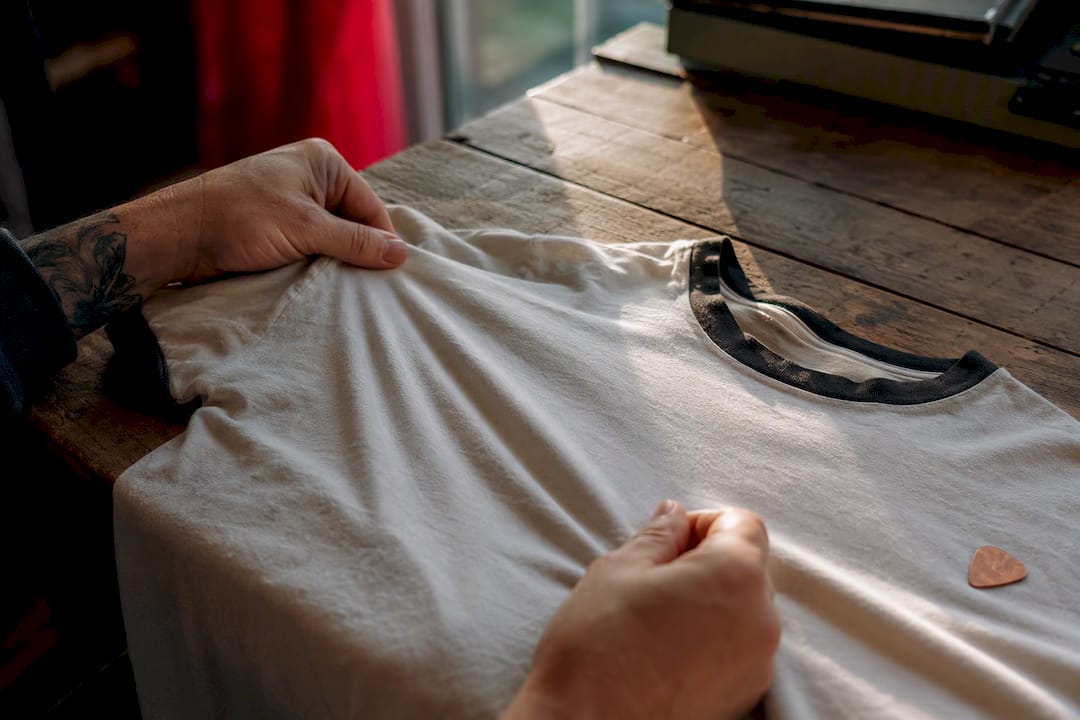 Hands feeling lightweight vintage tee fabric