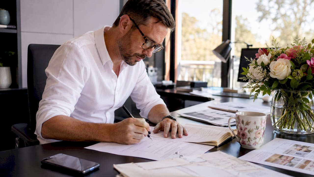 The role of venue coordinators at your wedding 1 Venue coordinator marking wedding day timeline