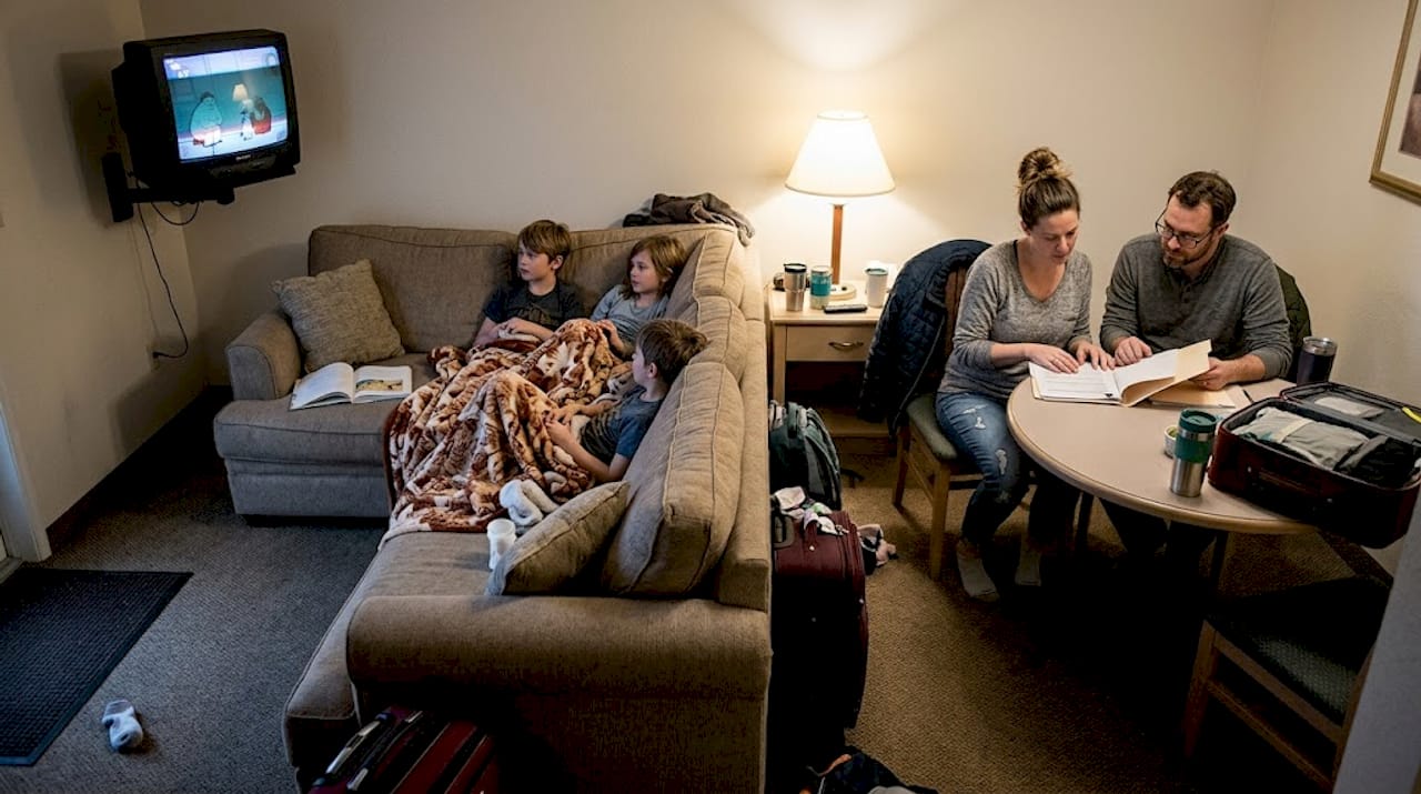 Family relaxing in hotel suite evening