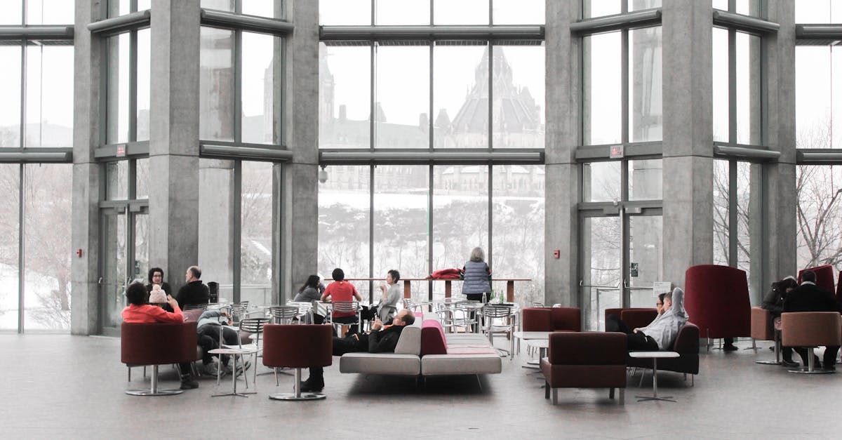 Modern office showing worker in task chair and team in conference chairs
