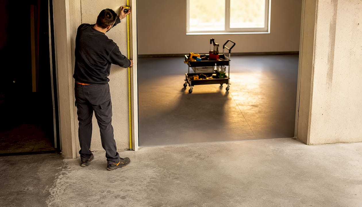 Due mani vengono usate per misurare la larghezza del garage.