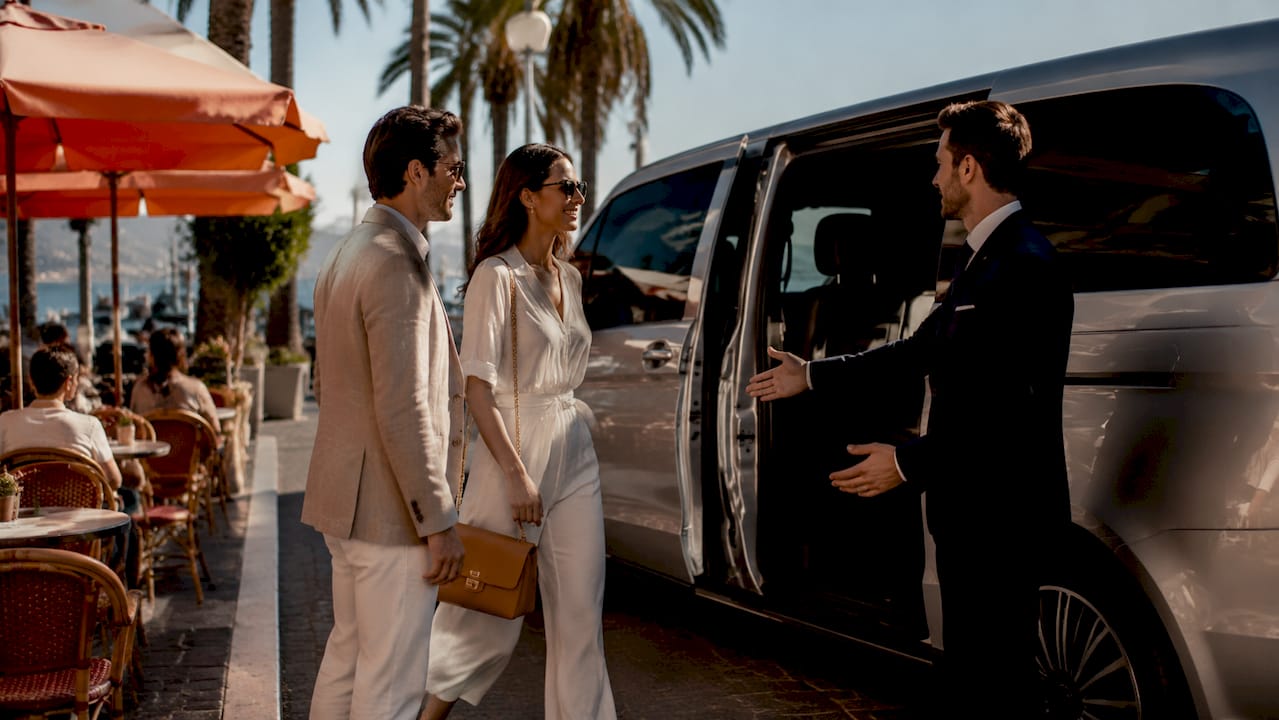 Mercedes-Benz van with chauffeur greeting luxury passengers at Nice Côte d'Azur Airport