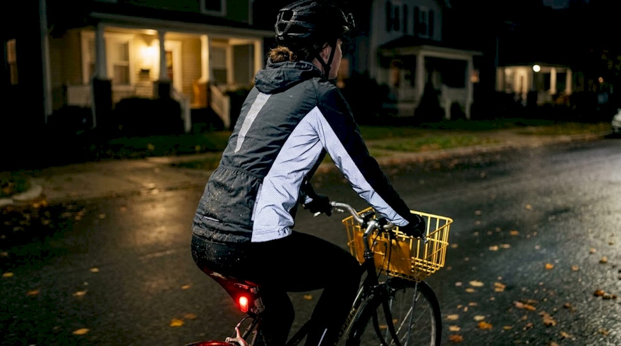 Cyclist wearing reflective jacket at night
