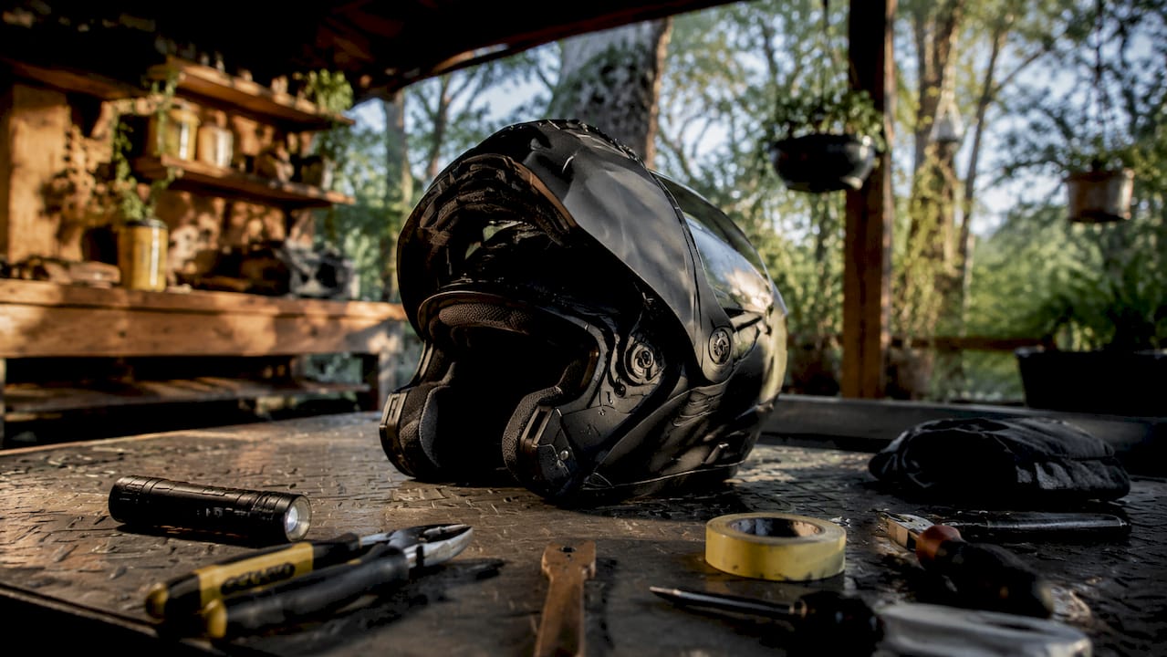 Close-up of modular helmet hinge and padding on workbench