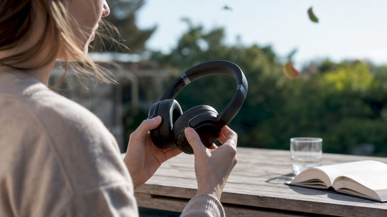 Zoom sur des mains qui tiennent un casque noir dernier cri.