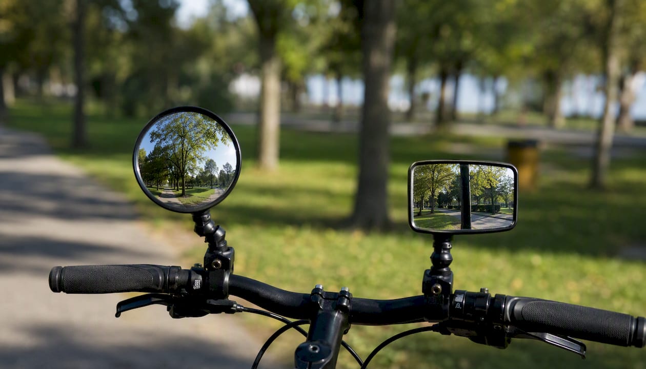 Side-by-side convex and flat cycling mirrors on handlebars