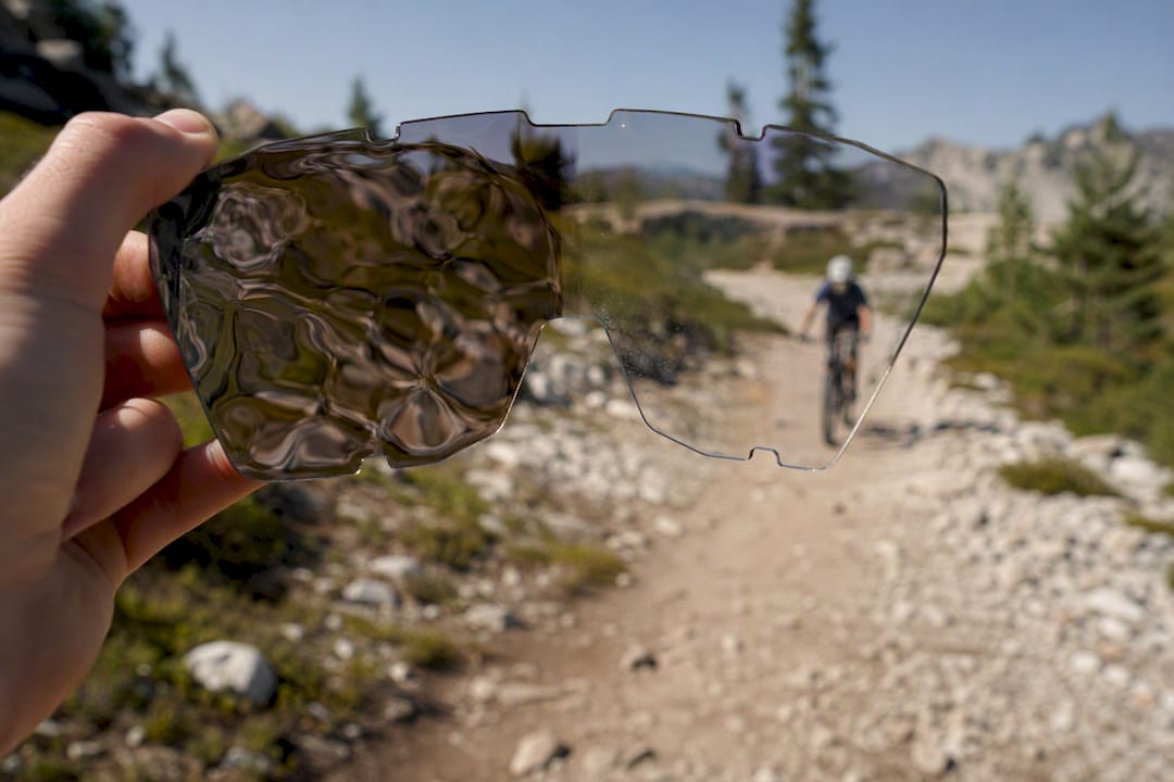 Distorted helmet visor showing road hazards