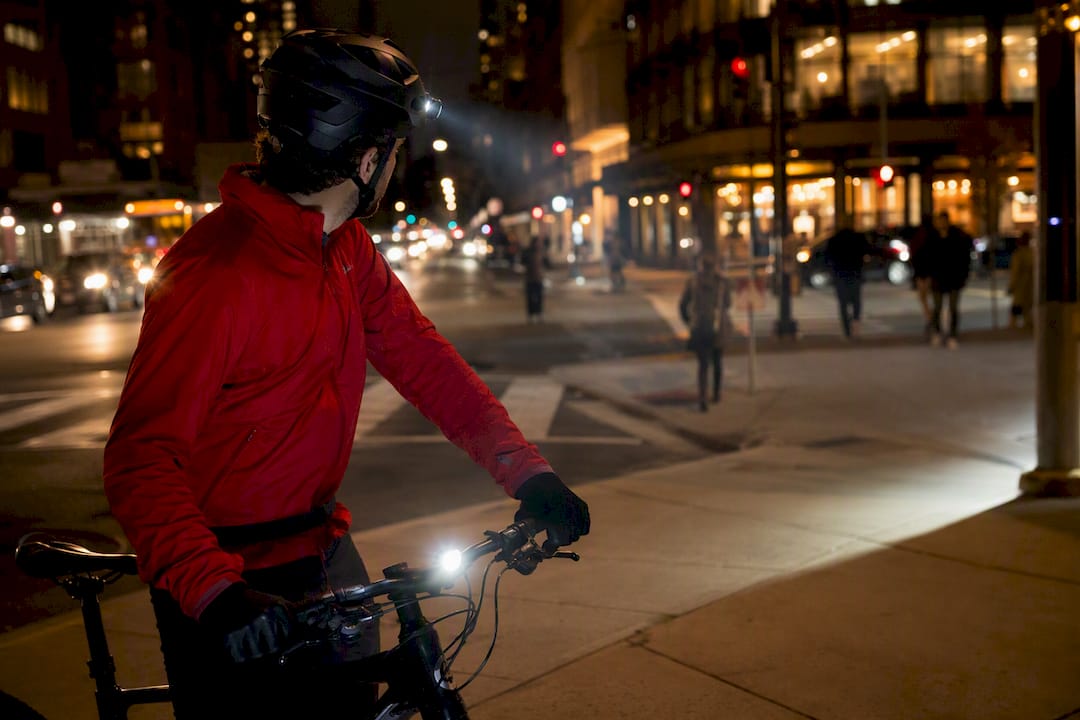 Cyclist at intersection with helmet and handlebar lights