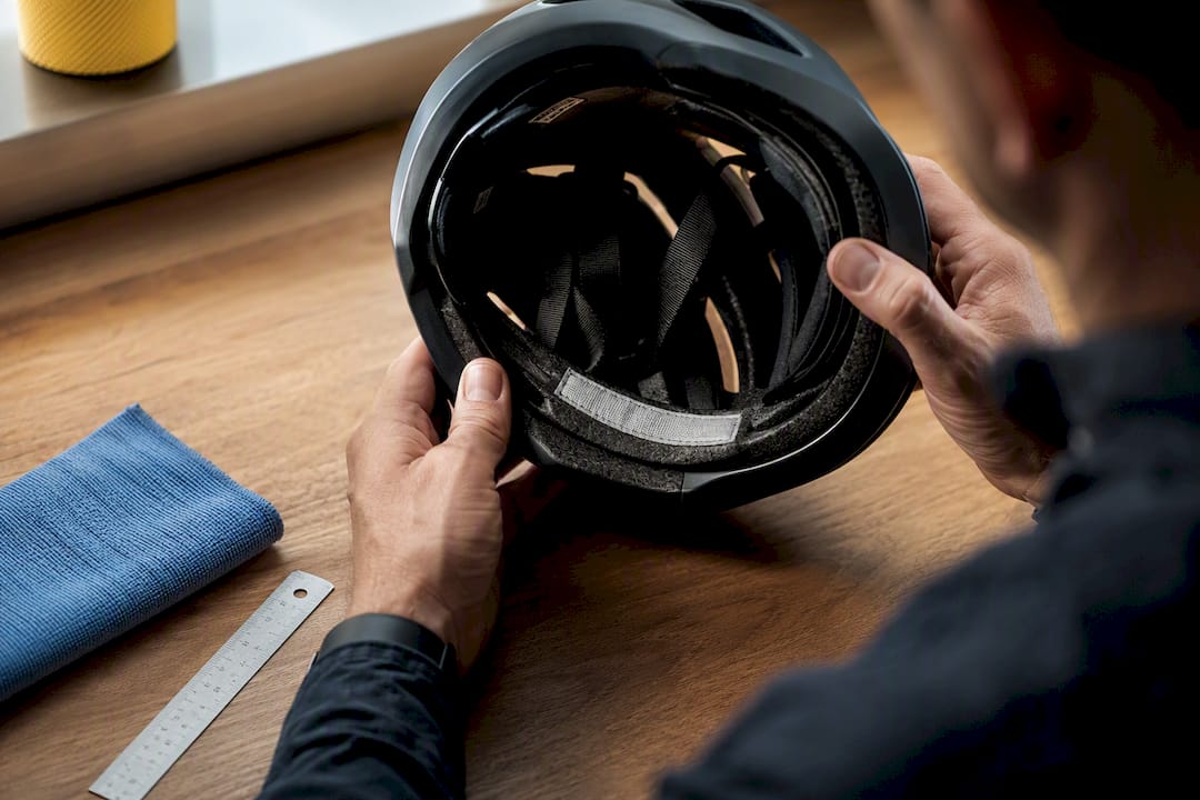 Hands checking helmet certification label