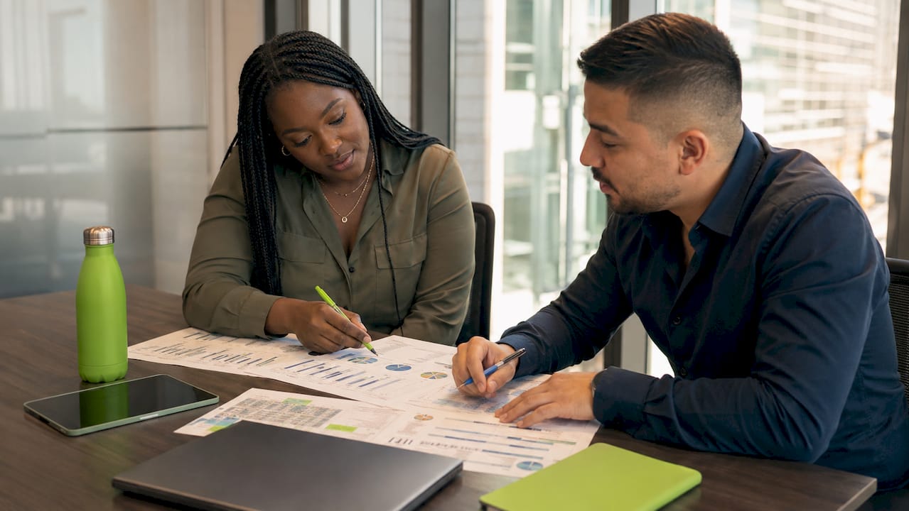 Overhead view of two professionals planning SEM and SEO