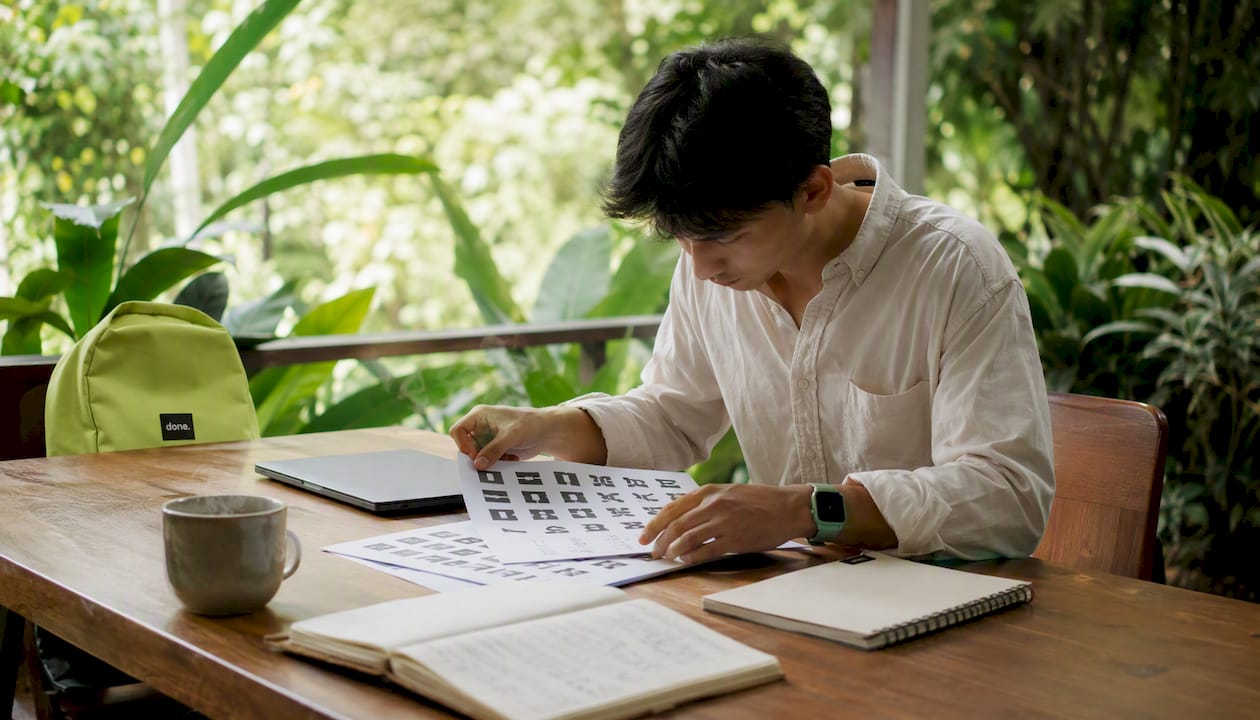 Man reviewing typography samples in coworking space