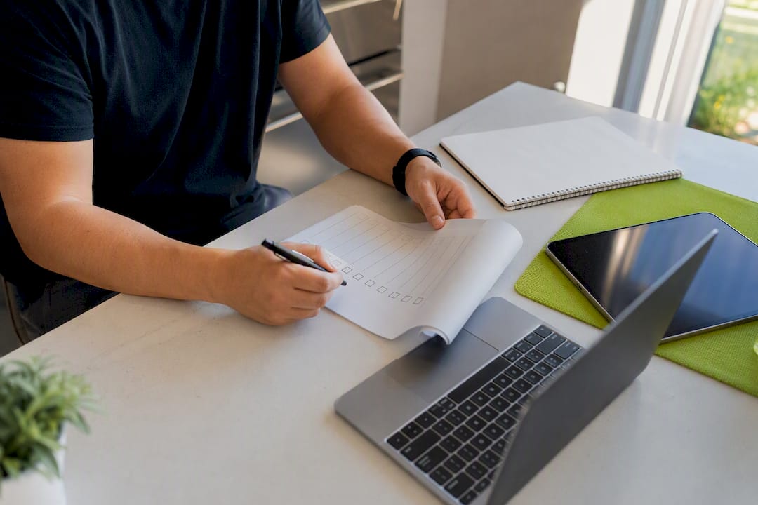 Hands marking checklist on desk