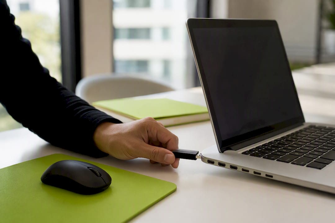 Hand connecting USB drive for data tracking