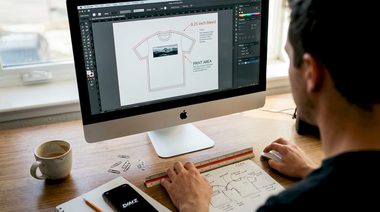 Hands adjusting DTF file bleed margin on monitor