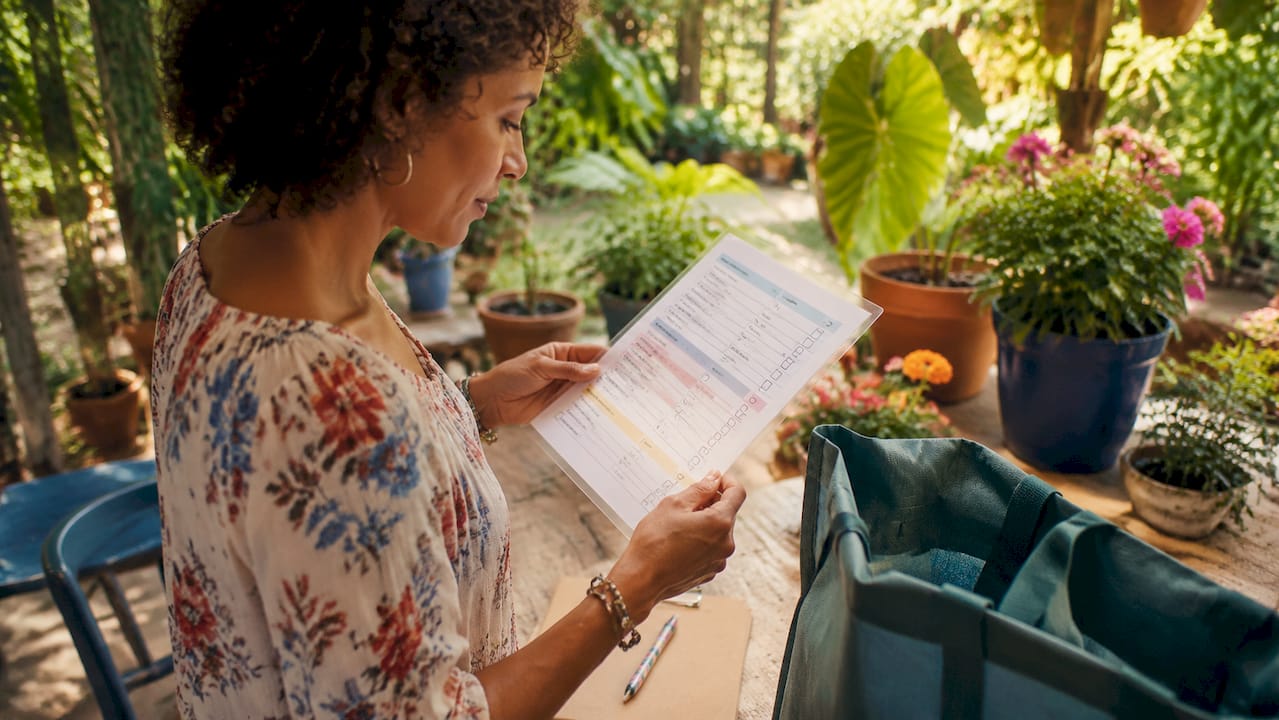 Hands holding a categorized shopping list