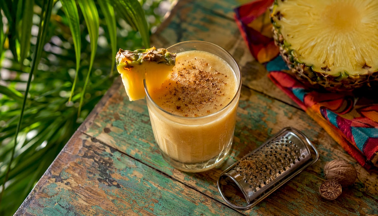 Close-up of Painkiller cocktail with pineapple garnish