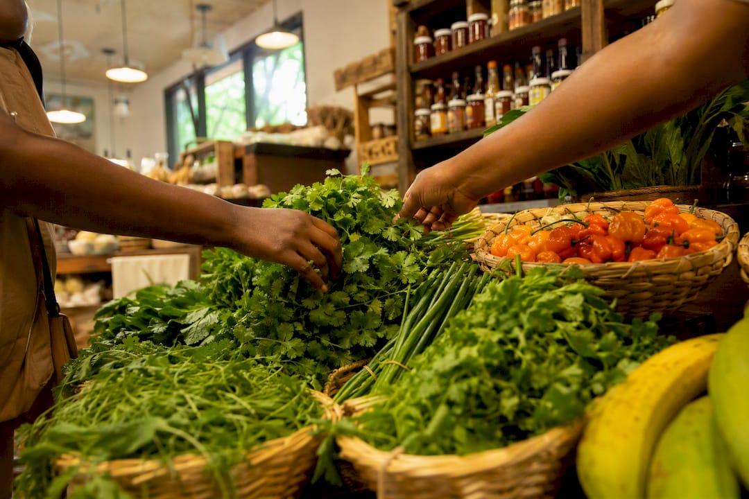 Fresh herbs displayed in Caribbean grocery store aisle