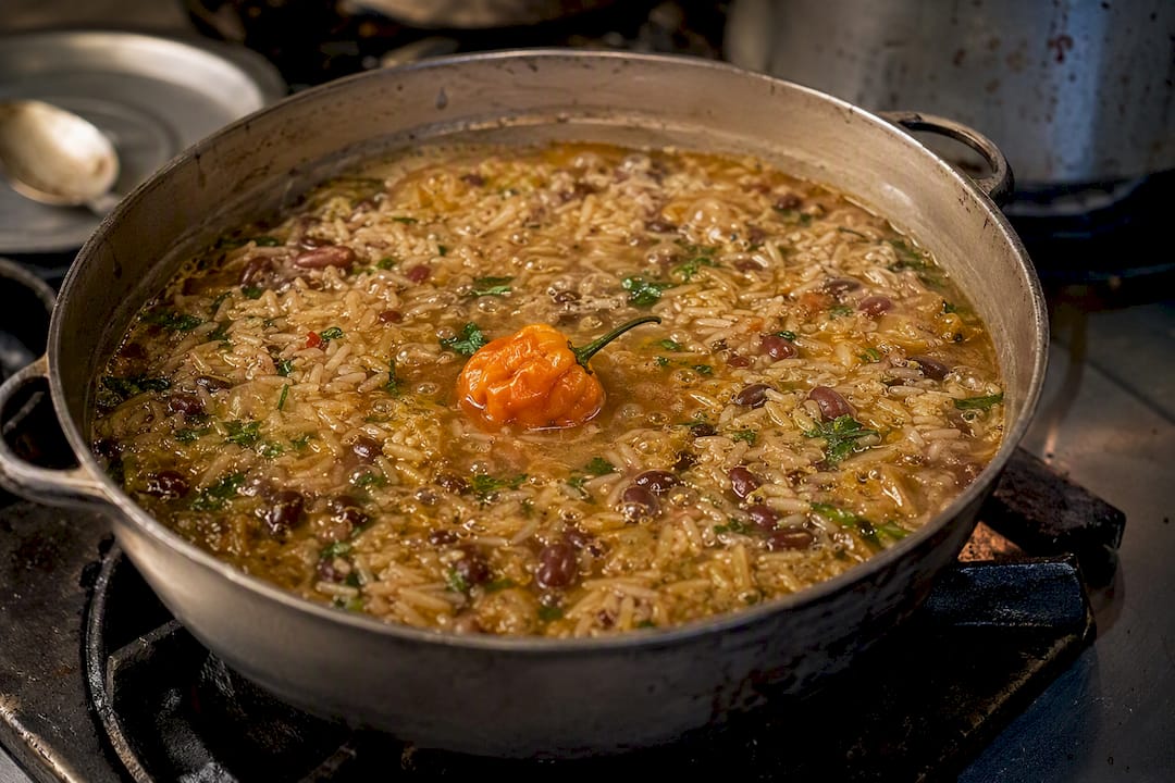 Whole Scotch bonnet pepper simmering in pot