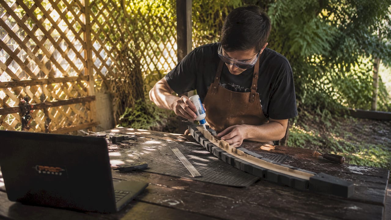 Hands building cosplay weapon core structure