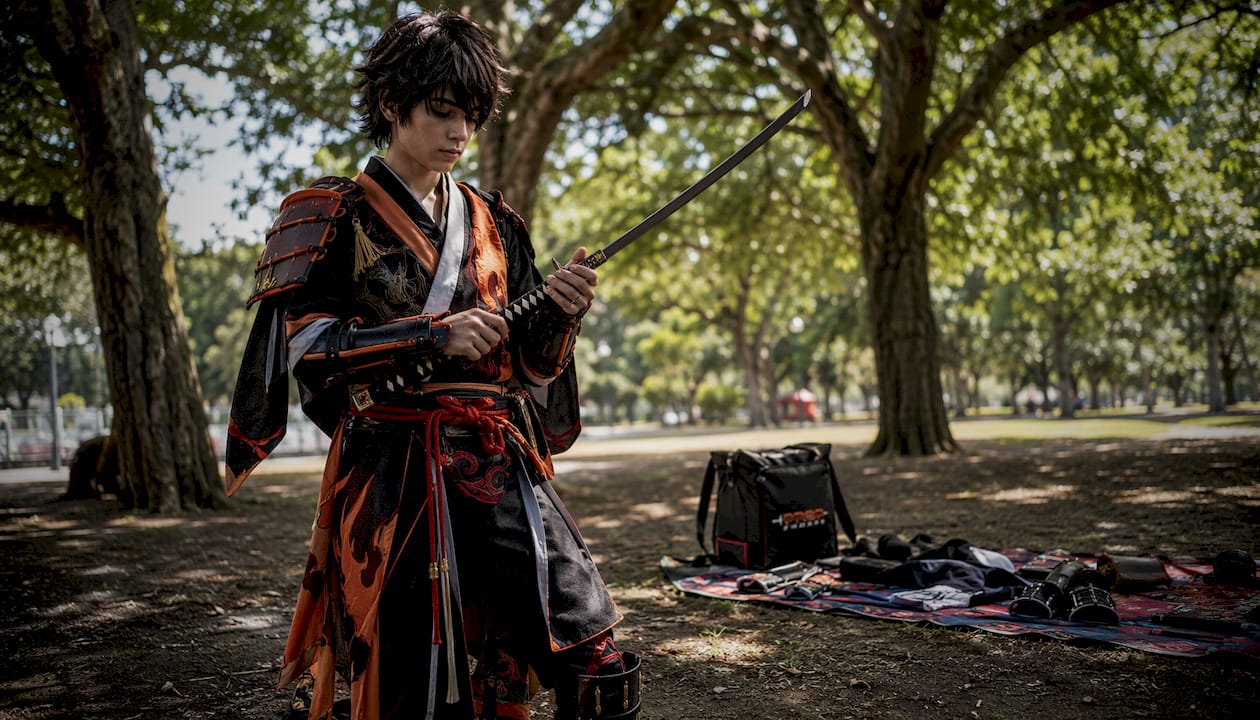 Teen cosplayer holding replica katana indoors