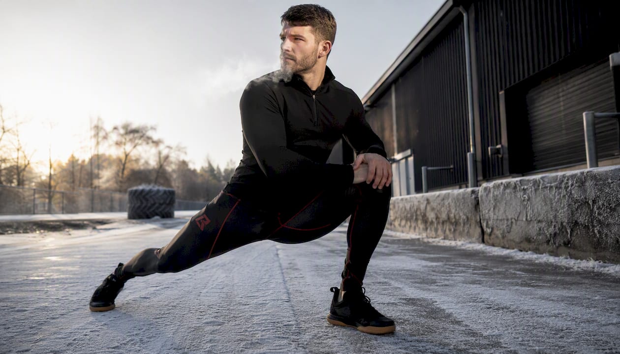 Male fighter warming up in winter compression pants outdoors