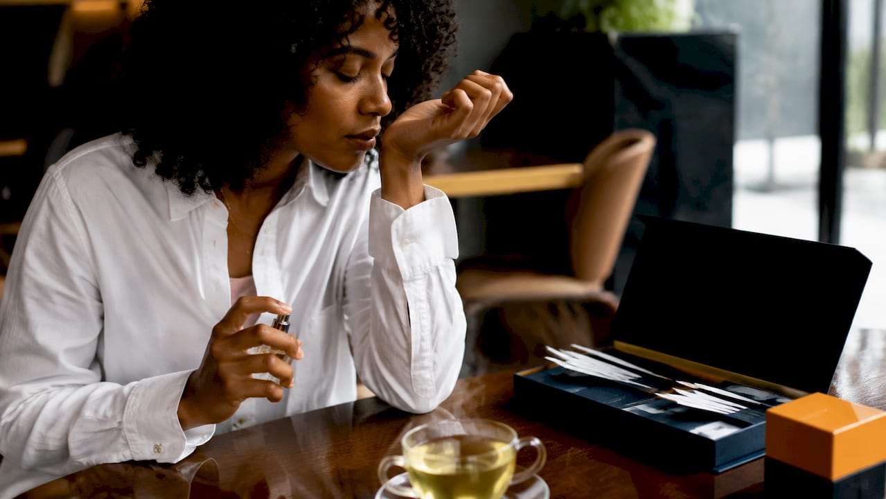 Person testing unisex fragrance on wrist