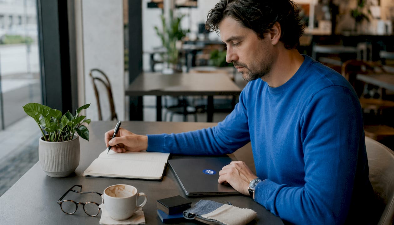 Man writing product review article at desk