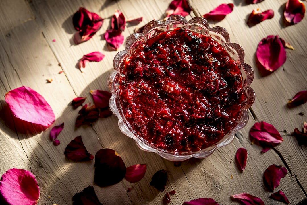 Fruit compote with red rose petals