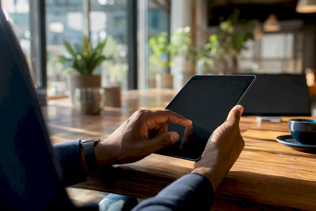 Hands holding tablet poised for website audit