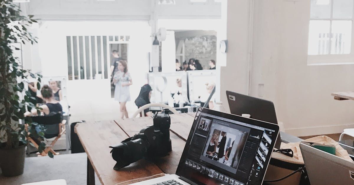 Coworkers collaborate in creative minimalist studio with text on wall