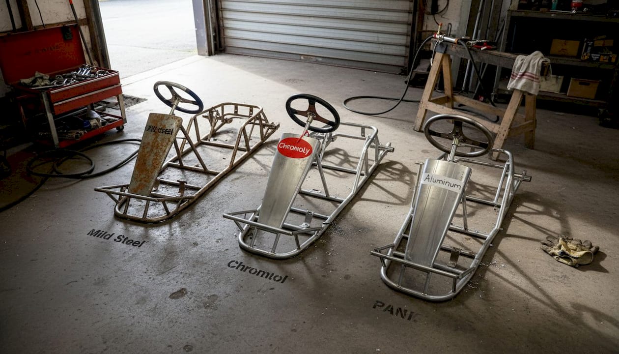 Three go-kart frames made from different materials side by side