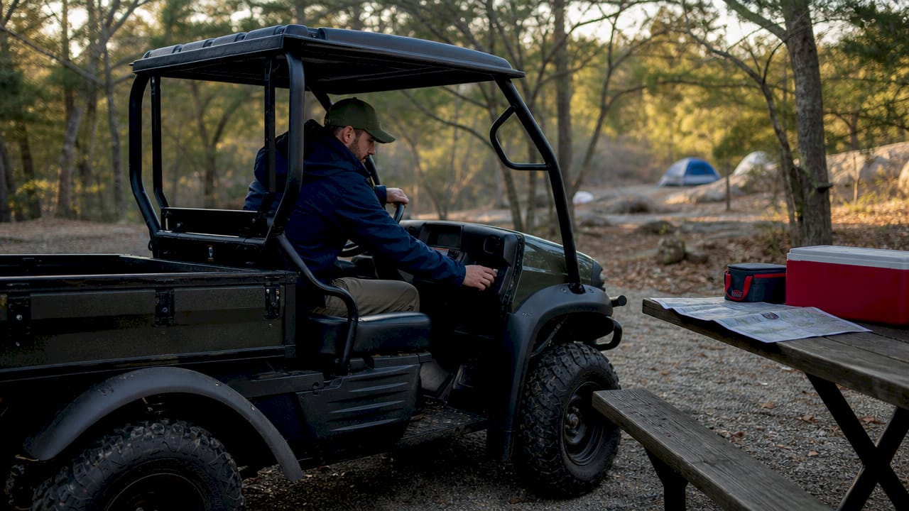 Man testing Kawasaki Mule SX UTV outdoors