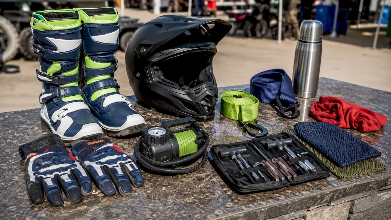 Off-road riding gear arranged on wooden table
