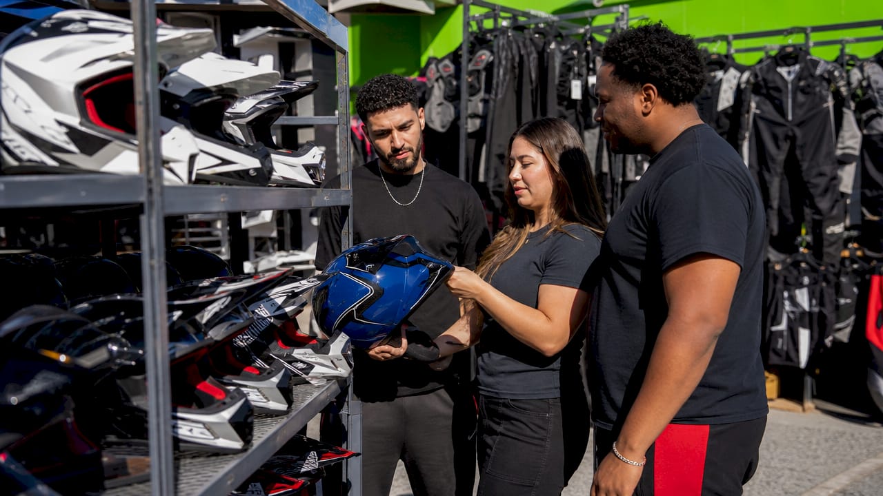 Hands inspecting powersports safety gear