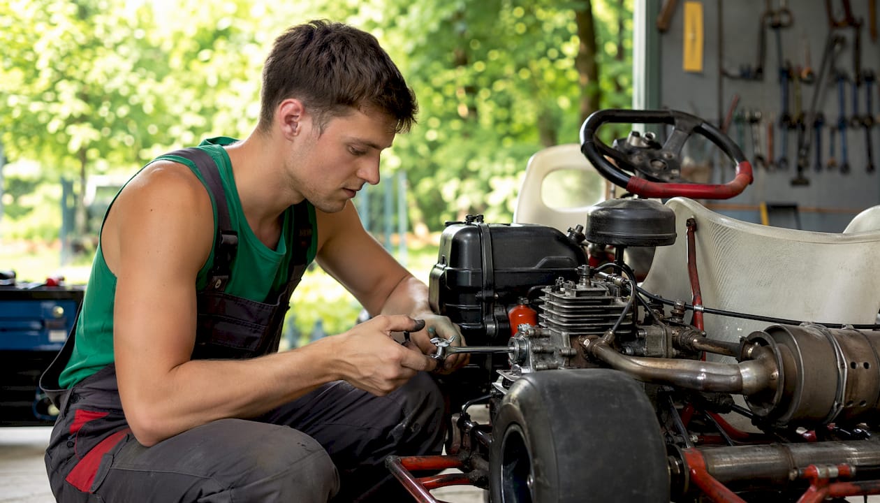 Mechanic hands repairing gas engine in garage
