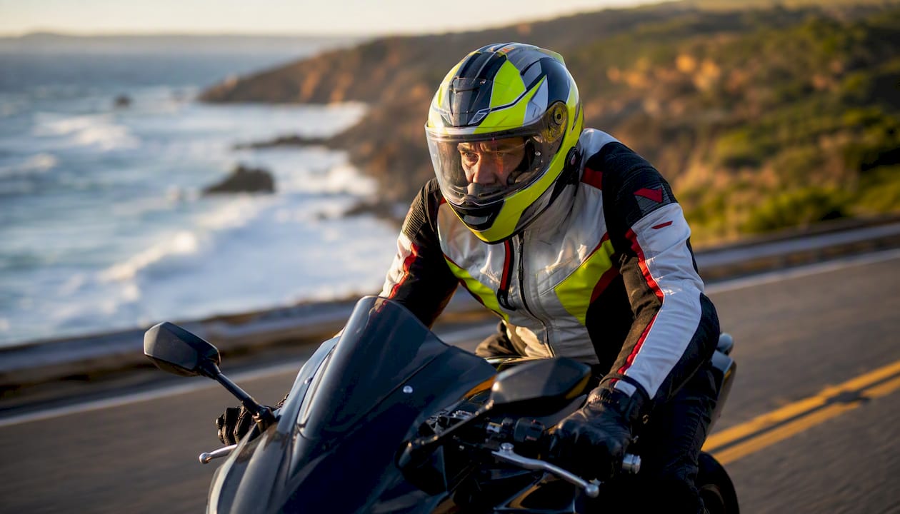 Motorcyclist leaning into crosswind with tucked elbows